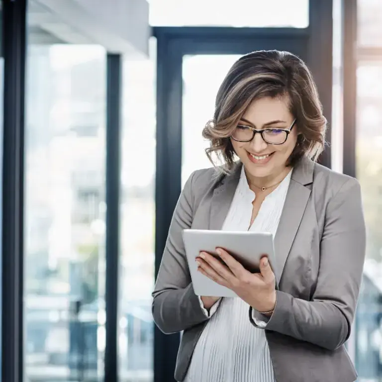 Hands holding a tablet which is displaying a speed gauge