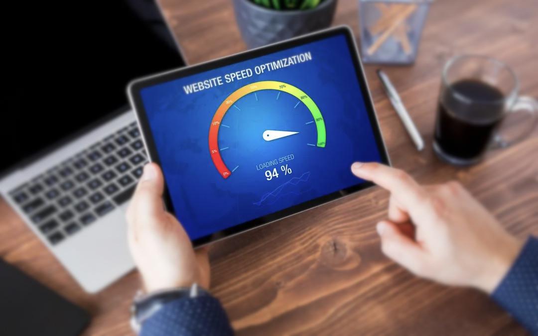 Hands holding a tablet which is displaying a speed gauge